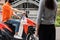 Food deliveryman wait customer on motorbike