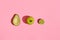 Food design. Composition of fresh fruits, avocado green apple and half of cutted avocado on pink coral background