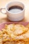 Food and dessert. Crackled crispy cookies with sugar on a plate and a cup of coffee on a wooden table.