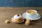 Food and drink concept. Coffee cup with traditional donuts sufganiyah for Hanukkah on wooden table
