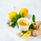 Food and drink, still life health care concept. Ginger tea infusion beverage in white cup with lemon mint honey on a kitchen table