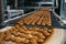 Food factory, production line or conveyor belt with fresh baked cookies. Modern automated confectionery and bakery