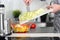 Food, family, cooking and people concept - Man chopping a cabbage on cutting board with knife in kitchen