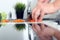 Food, family, cooking and people concept - Man chopping a carrot on cutting board with knife in kitchen