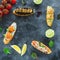 Food frame of sandwiches with prawn, salmon, mushroom and limes on dark background. Restaurant food