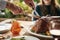 Food, hands and turkey with family at a table in celebration of thanksgiving, tradition and lunch meal on a patio