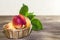 Food, harvest, fresh fruit. Ripe fruit of juicy peach with water drops and leaves in a wicker basket on a wooden background in a