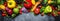 Food, healthy and useful multicolored vegetable and herbs on gray background, top view. Panoramic banner with copy space