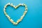 Food. Image of the Heart Forms from Popcorn. Delicious Popcorn on Blue Background. Cinema.
