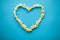 Food. Image of the Heart Forms from Popcorn. Delicious Popcorn on Blue Background. Cinema.