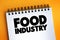 Food Industry text quote on notepad, concept background
