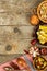 Food ingredients on a wooden background. Place for text. Restaurant menu. Recipe for chefs. Spices and stuffed green olives.