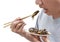 Food Insects: Man eating Cricket insect on chopsticks. Crickets deep-fried crispy for eat as food snack, it is good source of