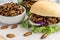 Food Insects: Silkworm Pupae insect deep-fried for eating as food in bread burger with vegetable and bowl on wooden table, it is