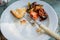 Food leftovers on the plate. Vegetables, meat and bread