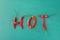 Food Lettering Typography. Word Hot Made from Red Spicy Chili Peppers on Green Background. Mexican Italian Spanish Greek Cuisine