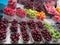 Food market. Counter with berries and fruits in plastic containers and boxes