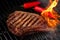 Food meat - beef steak on bbq barbecue grill with flame