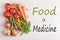 Food is Medicine text with assorted vegetables