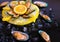 Food. mussels, vegetables, yellow plate, black background, ice