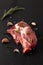 Food organic Fresh Crude Pork Neck on black slate stone with copy space