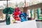 Food and other grocery items wrapped in green, red, and blue water cellophanes and flower ready on the table for offertory