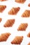 Food pattern with french homemade croissants on a white background.