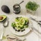 Food photo mix lettuce with avocado, feta cheese and mint sauce