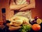 Food photo of unrecognizable man cooking chicken in the kitchencook in apron on orange background