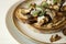 Food photography of a crostini toasted bread with sautÃ©ed mushrooms on mushroom patÃ©