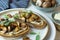 Food photography of a crostini toasted bread with sautÃ©ed mushrooms on mushroom patÃ©