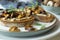 Food photography of a crostini toasted bread with sautÃ©ed mushrooms on mushroom patÃ©