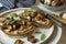 Food photography of a crostini toasted bread with sautÃ©ed mushrooms on mushroom patÃ©