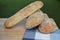 Food photography of fresh home made artisan ciabatta bread on a wood board with blue check pattern table cloth taken outside