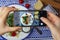 Food photography:the girl is taking a photo of Caesar salad. Food photo for social networks