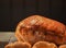 Food photography of hot cooked and resting roast gammon or ham joint of meat on a black background with yorkshire puddings