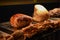 Food photography of hot cooked and resting roast gammon turkey and beef joints on a black background with yorkshire puddings