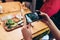 Food photography for social networks. Close-up image of female hands holding phone with food on screen taking picture of