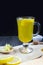 Food photos. Tea with ginger, lemon, turmeric and honey on a wooden board on a dark background. A remedy for colds, a medicinal dr