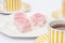 Food : Plate of pink iced sponge cakes with cups of tea. 7