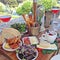 Food platter with cheese, bread, prawns and rose wine served out