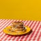 Food pop art photography. Plate with pancakes with funny drawings on plaid tablecloth isolated on bright yellow