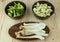 Food preparation on the bowls. The ingredients include fresh green broccoli, Pleurotus Eryngii, and Cauliflower