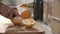 Food Preparation. Man Cutting Orange With Knife Closeup