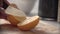 Food Preparation. Man Cutting Orange With Knife Closeup