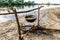 food preparing in cauldron on campfire at river shore, polesie,