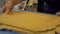 Food production. A man working with a large piece of rolled dough. Close-up