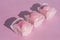 Food : Row of pink iced sponge cakes on a pink background. 6