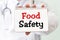 FOOD SAFETY card in hand of medical doctor, concept