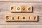 Food safety word written on wood block. Food safety text on table, concept